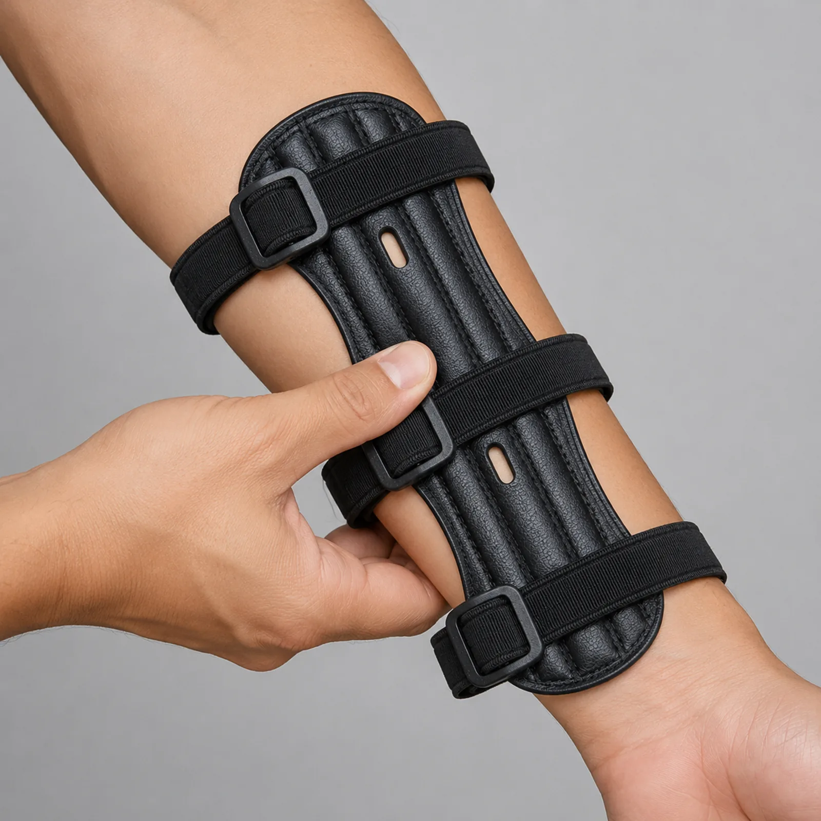 Thumb pushing sideways against the edge of a worn arm guard to check the plate does not rotate
